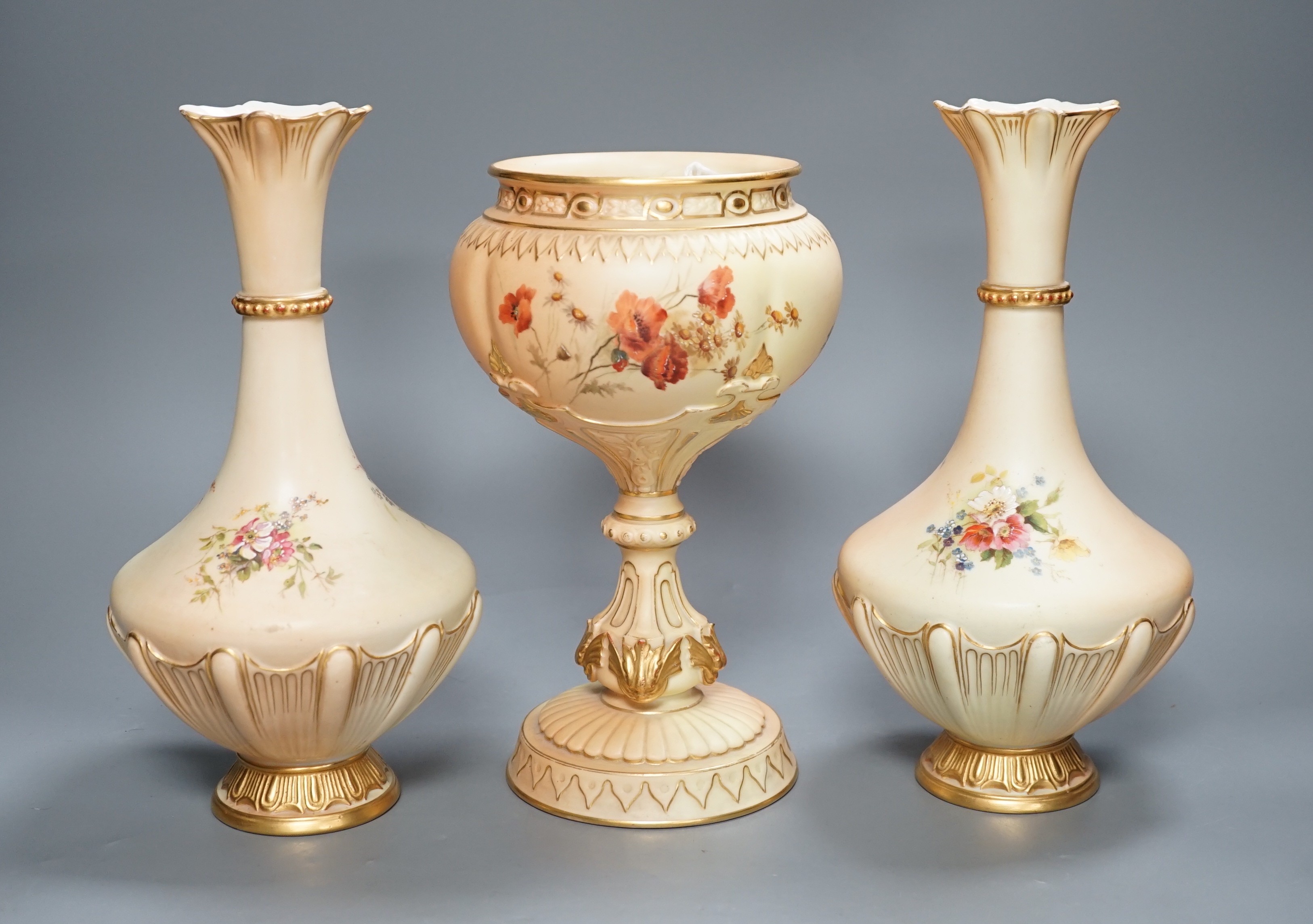 A pair of Royal Worcester blush ivory vases and a similar pedestal vase, tallest 27cm